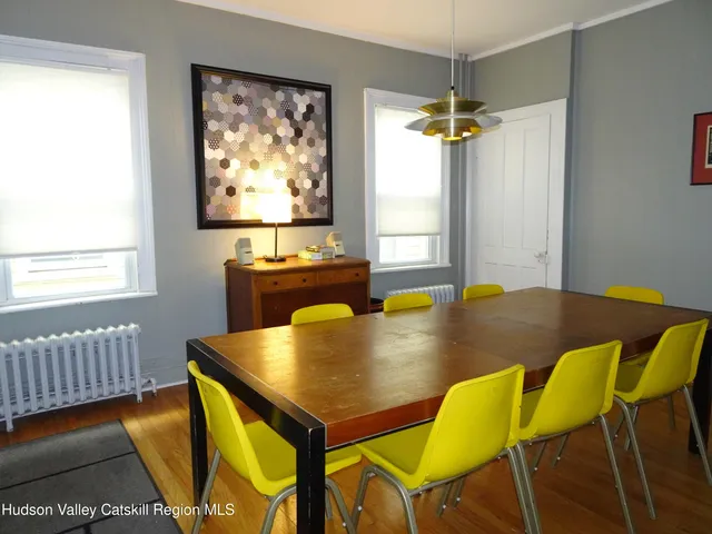 a view of a dining room with furniture and window