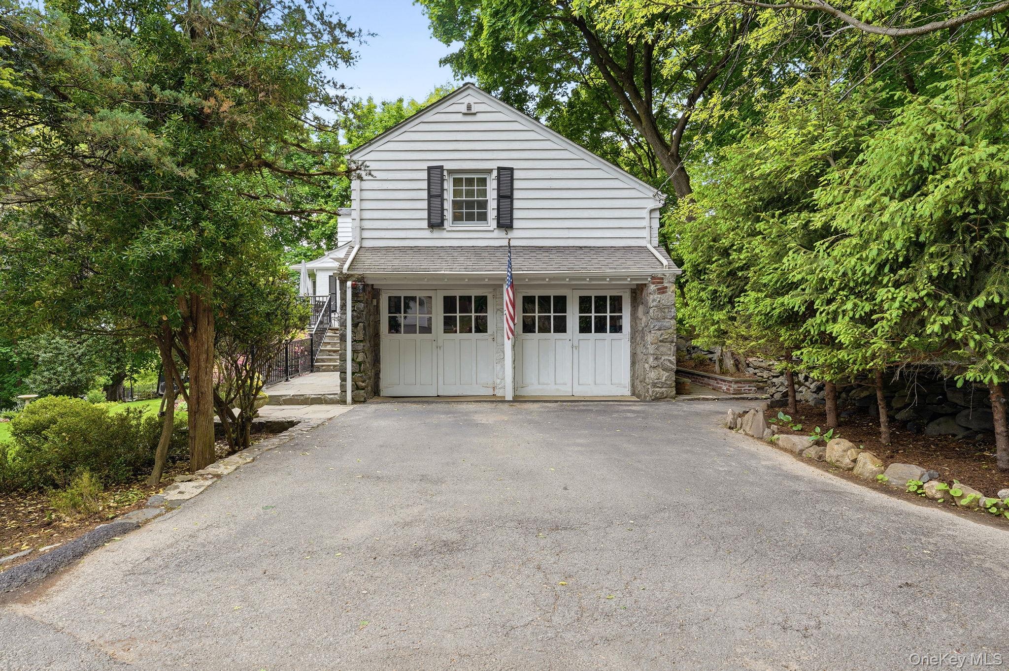 26 Cedarlawn Road Irvington, NY 10533 - Photo 28 of 34 a front view of a house with a garden