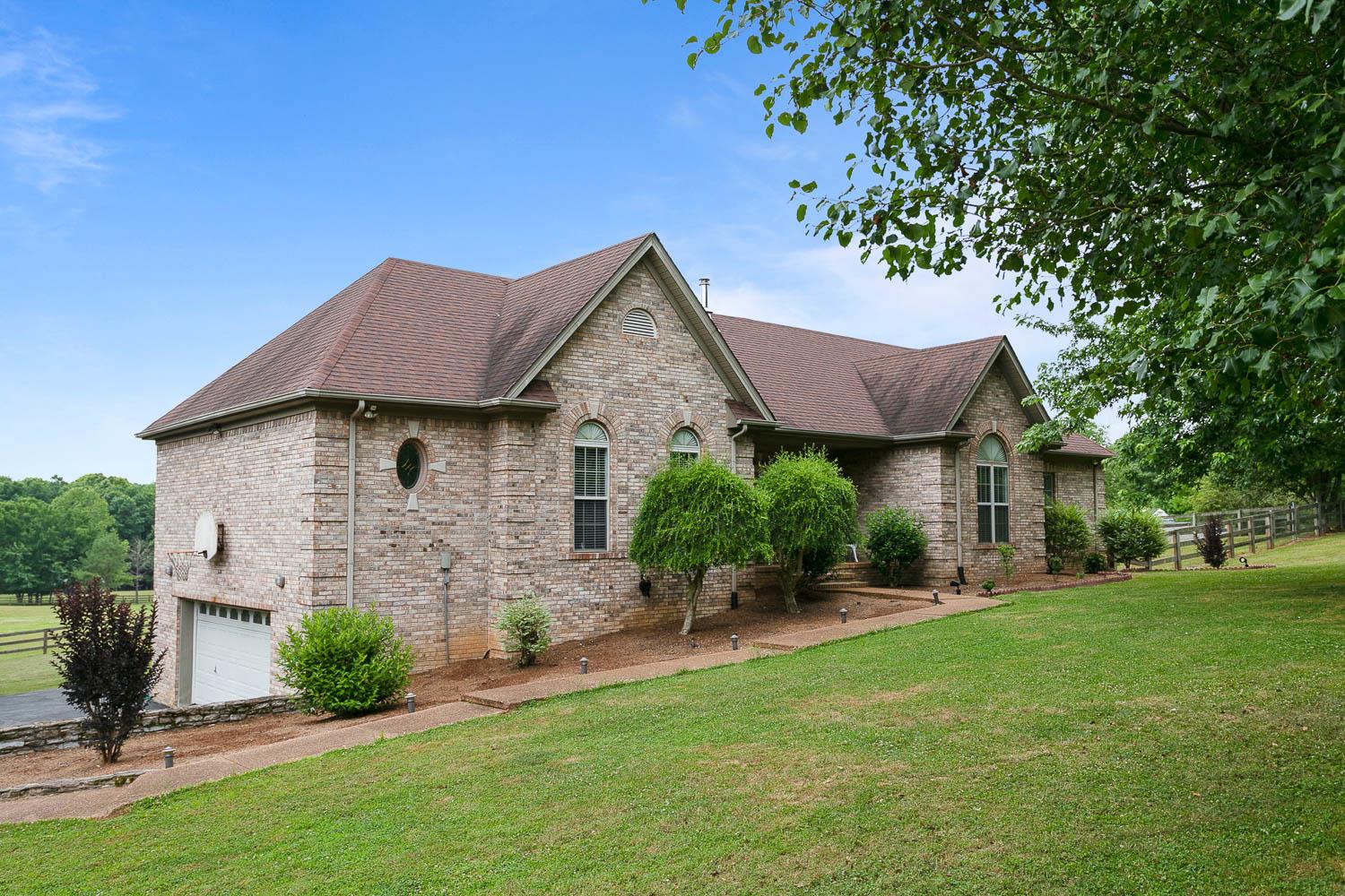 1018 Rip Steele Road Columbia, TN 38401 - Photo 1 of 28 a front view of a house with a yard and garage