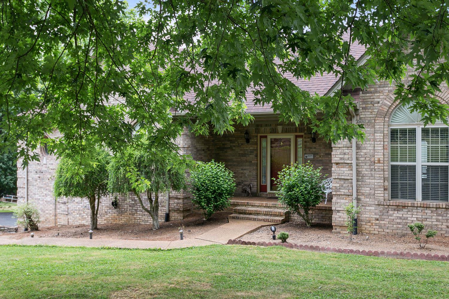 1018 Rip Steele Road Columbia, TN 38401 - Photo 2 of 28 a garden with trees in front of it
