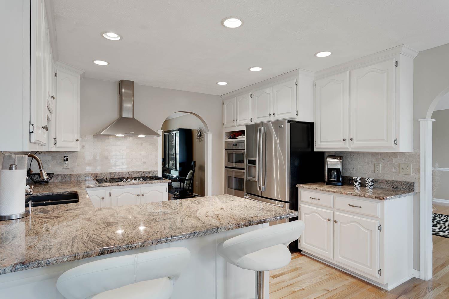 1018 Rip Steele Road Columbia, TN 38401 - Photo 10 of 28 a kitchen with stainless steel appliances granite countertop a sink refrigerator and cabinets