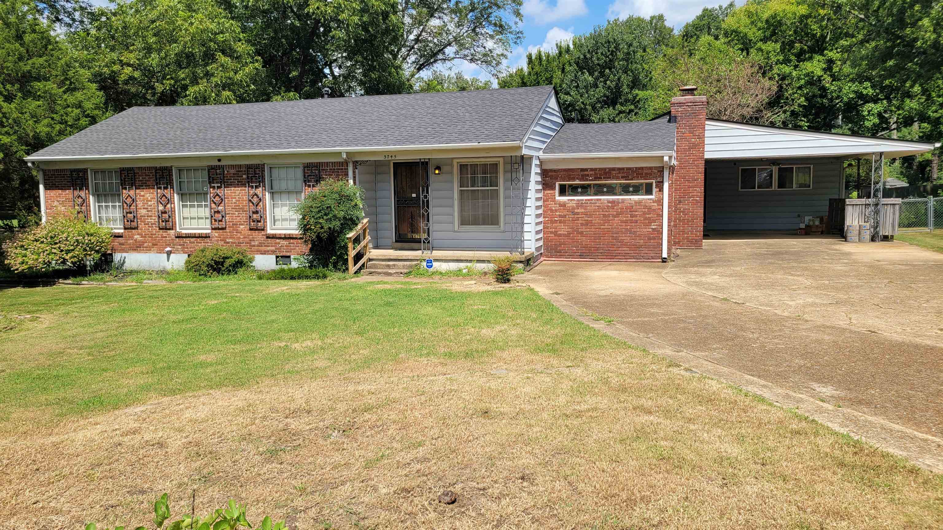 3745 Tchulahoma Road Memphis, TN 38118 - Photo 1 of 39 a front view of a house with a yard and garage