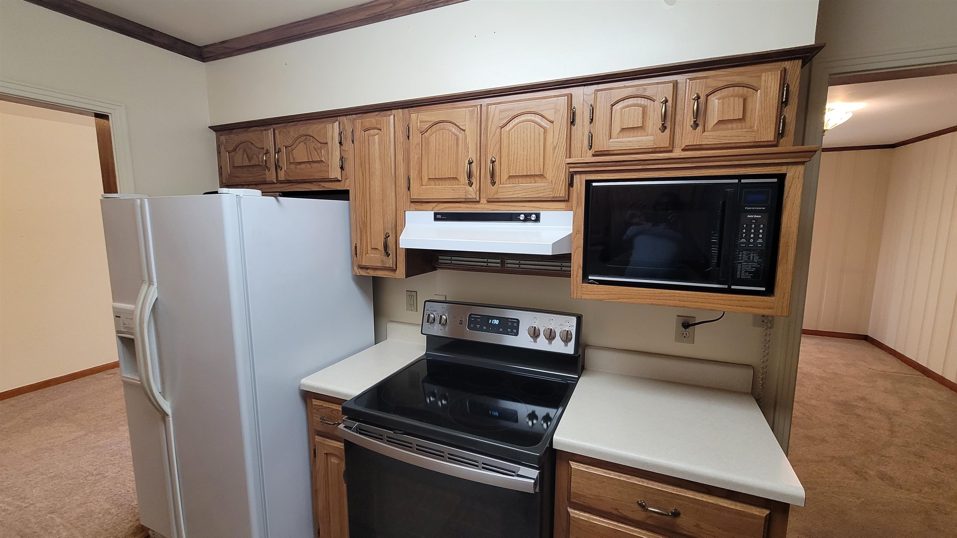 3745 Tchulahoma Road Memphis, TN 38118 - Photo 15 of 39 a kitchen with stainless steel appliances a stove a microwave and a refrigerator