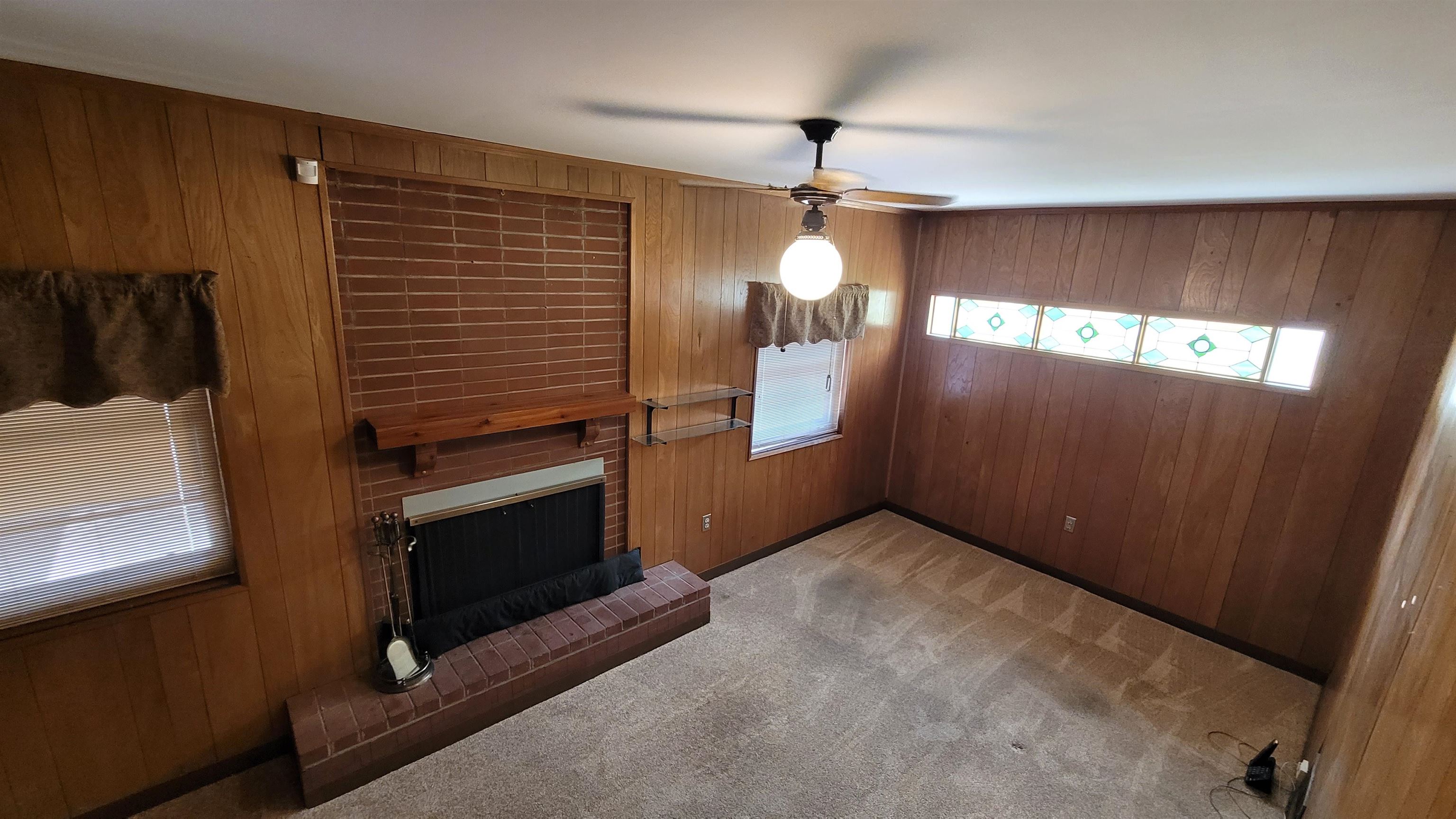 3745 Tchulahoma Road Memphis, TN 38118 - Photo 32 of 39 a view of an empty room with a fireplace and a window