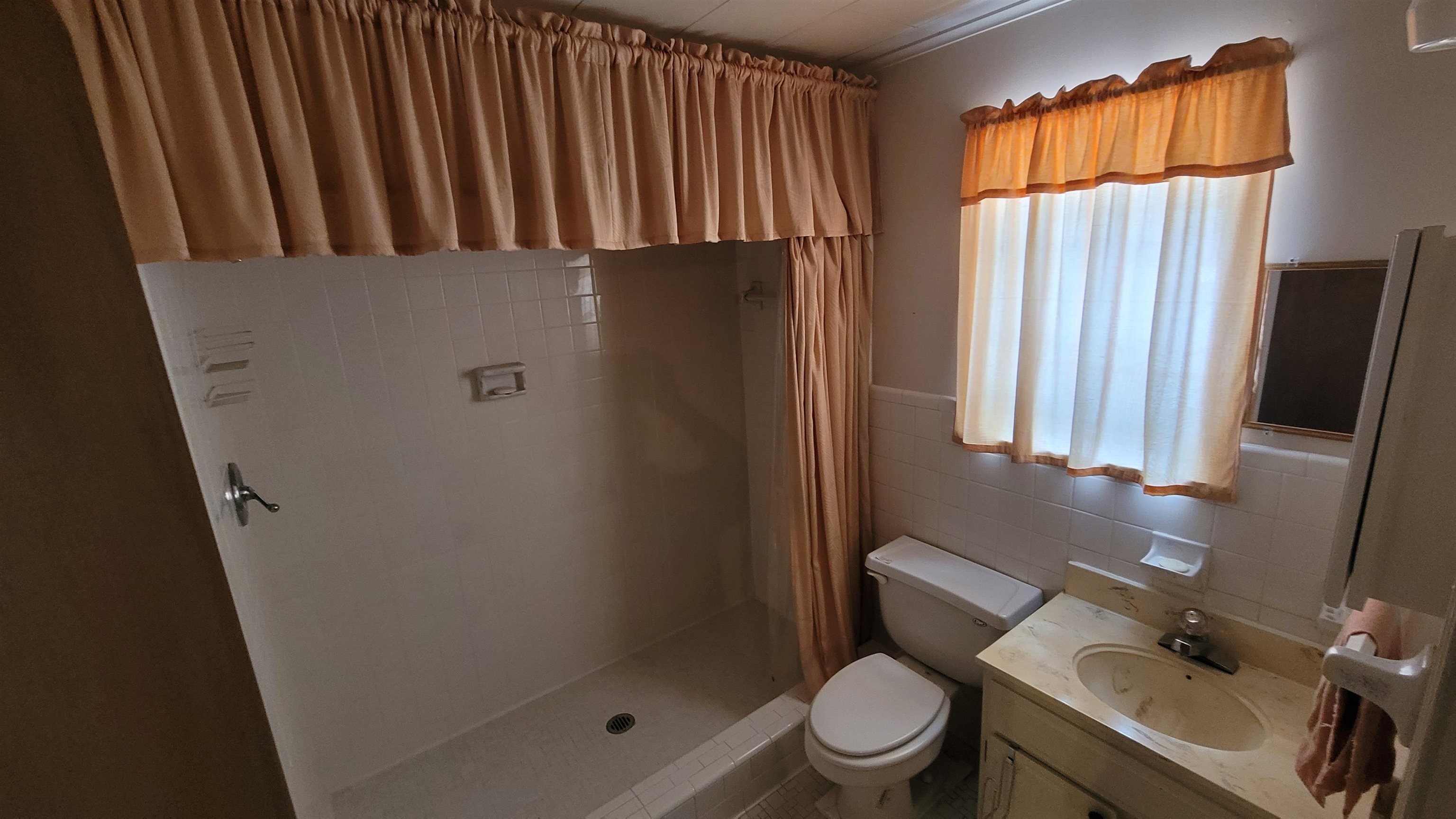 3745 Tchulahoma Road Memphis, TN 38118 - Photo 39 of 39 a bathroom with a toilet a sink and shower curtain