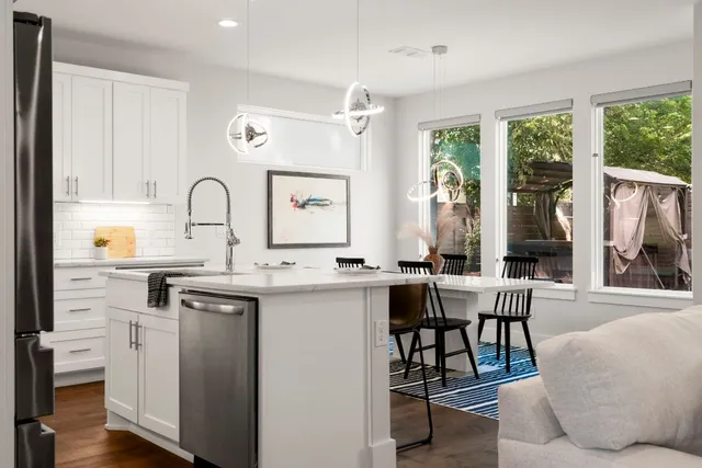 a kitchen with stainless steel appliances a stove a sink refrigerator and cabinets