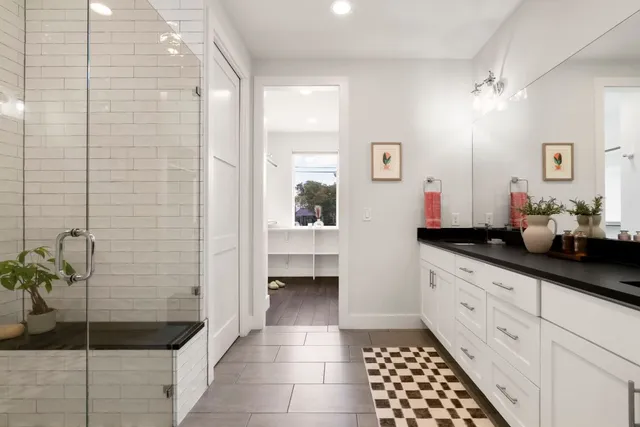 a bed room with a bed window and a flat screen tv
