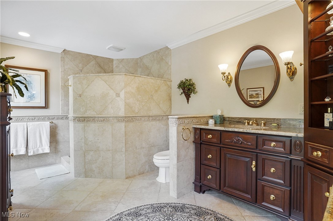 4432 Ira Road Akron, OH 44333 - Photo 25 of 50 Bathroom with tile walls, vanity, ornamental molding, tiled shower, and toilet