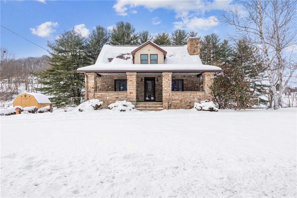 a front view of a house with a yard covered in snow