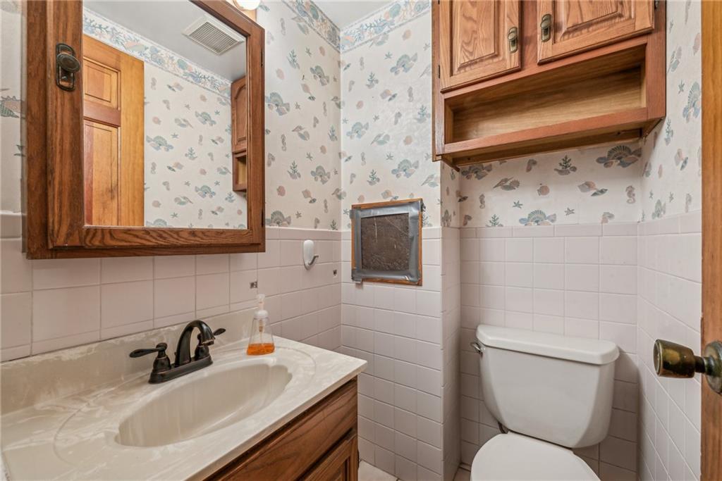 711 Pleasant Valley Road Connellsville, PA 15425 - Photo 13 of 46 a bathroom with a sink a toilet and mirror