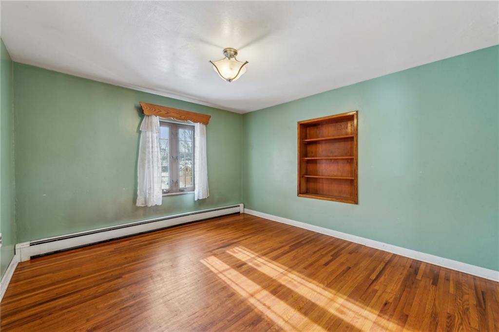711 Pleasant Valley Road Connellsville, PA 15425 - Photo 15 of 46 a view of an empty room with a window and wooden floor
