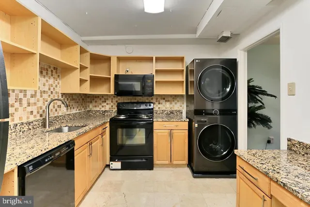 a kitchen with a stove top oven sink and cabinets