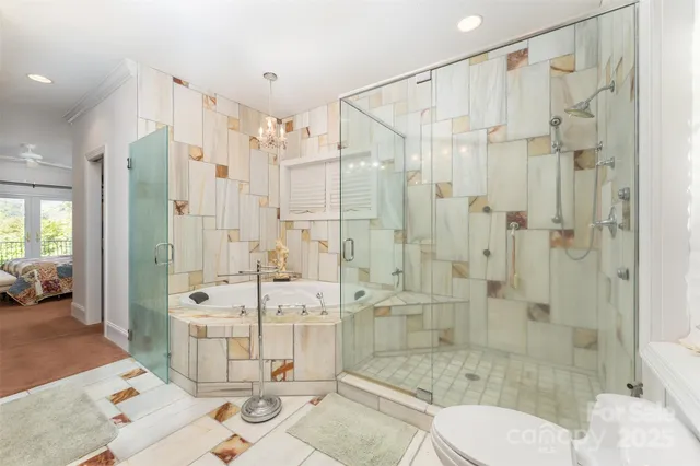 a bathroom with a shower sink mirror and toilet
