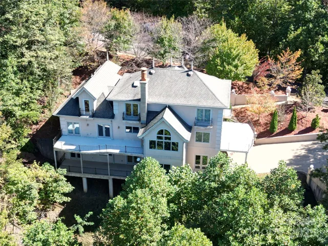 an aerial view of a house with a yard and potted plants