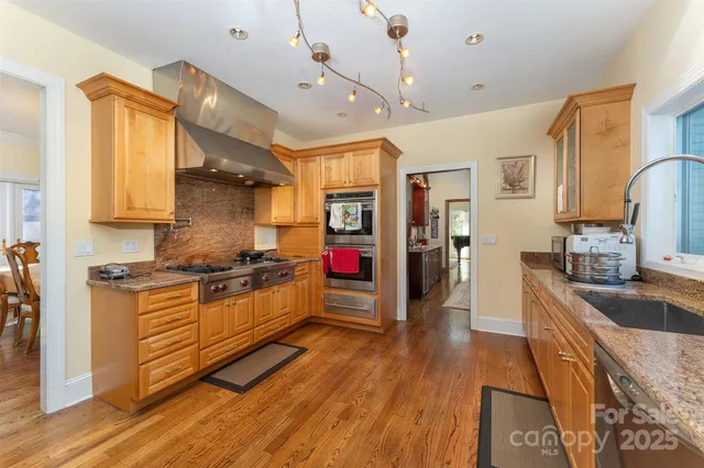 a kitchen with stainless steel appliances granite countertop a stove and refrigerator