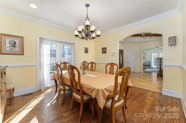a view of a dining room with furniture and chandelier