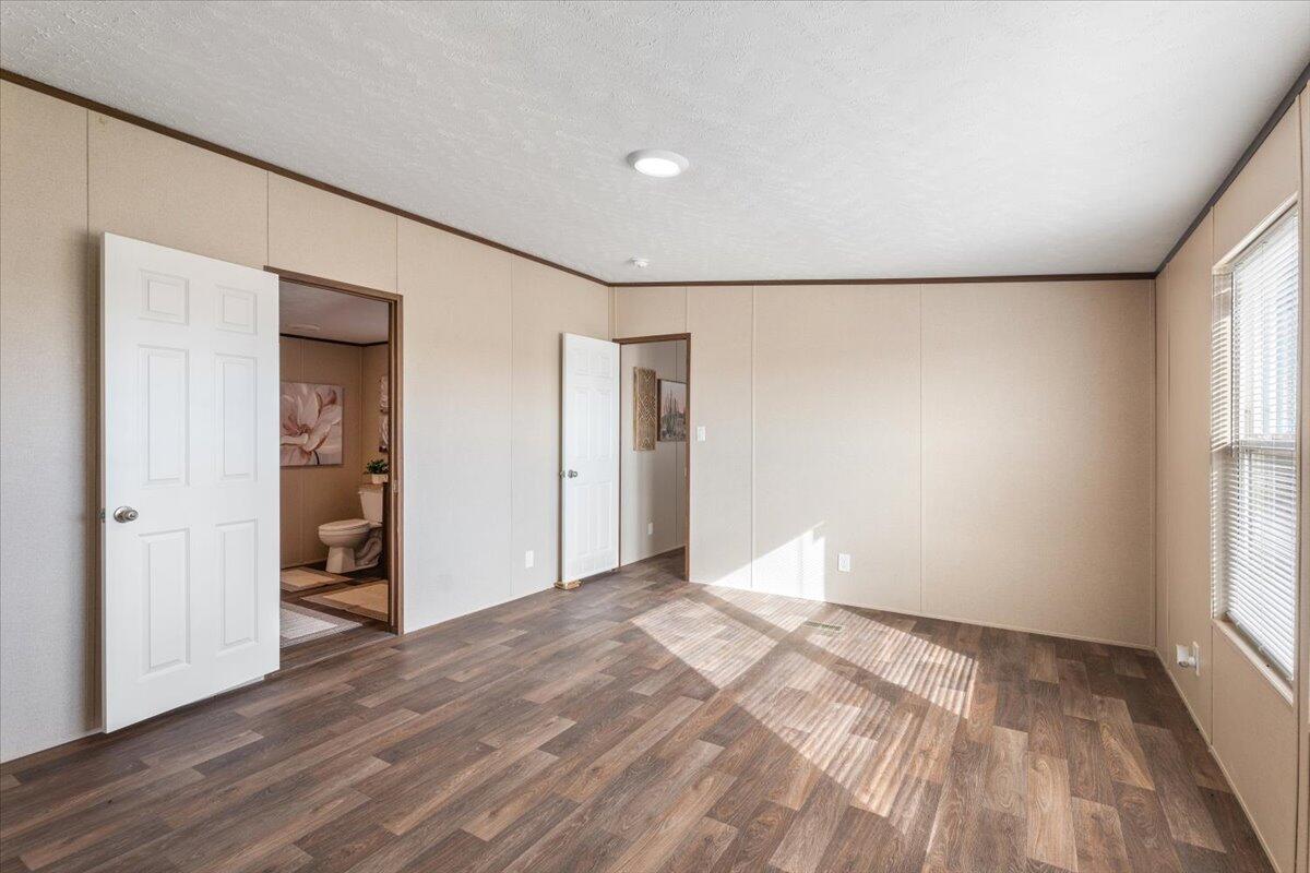 508 Sage Road Tahoka, TX 79373 - Photo 11 of 26 wooden floor in an empty room with a window