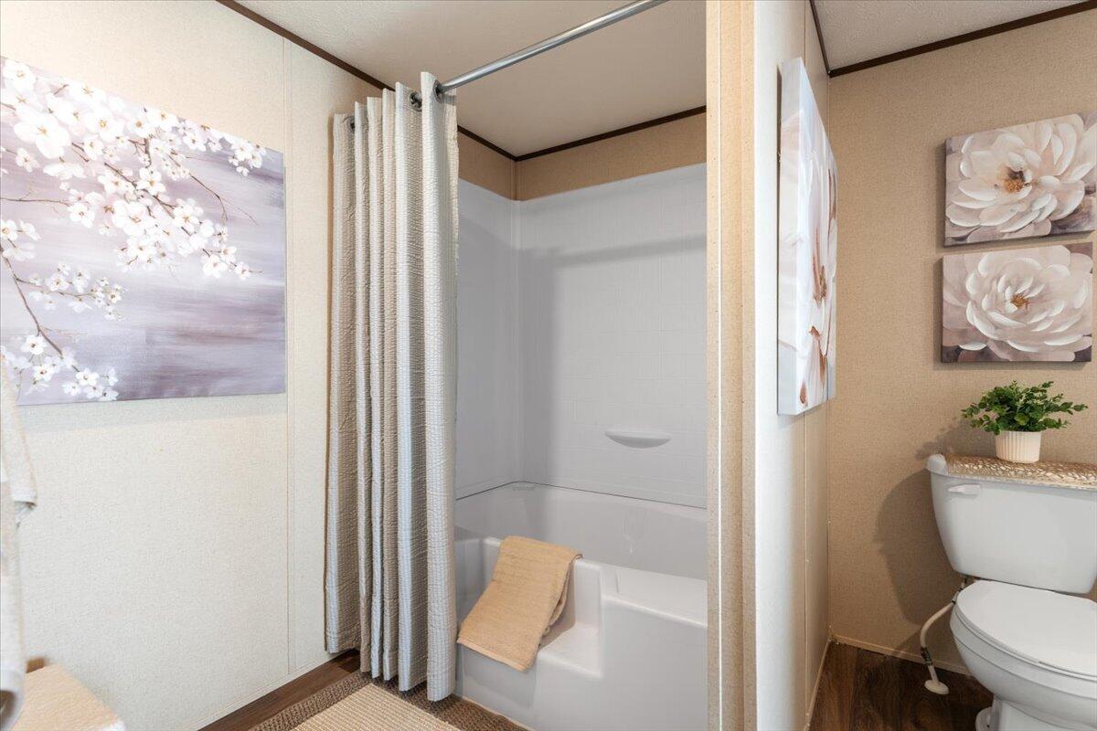 508 Sage Road Tahoka, TX 79373 - Photo 13 of 26 a bathroom with a toilet and a shower