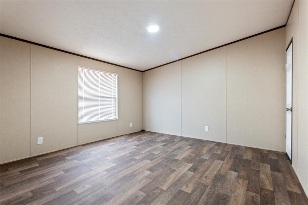 508 Sage Road Tahoka, TX 79373 - Photo 15 of 26 an empty room with wooden floor and windows