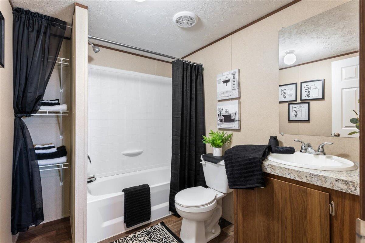 508 Sage Road Tahoka, TX 79373 - Photo 19 of 26 a bathroom with a granite countertop sink toilet and shower