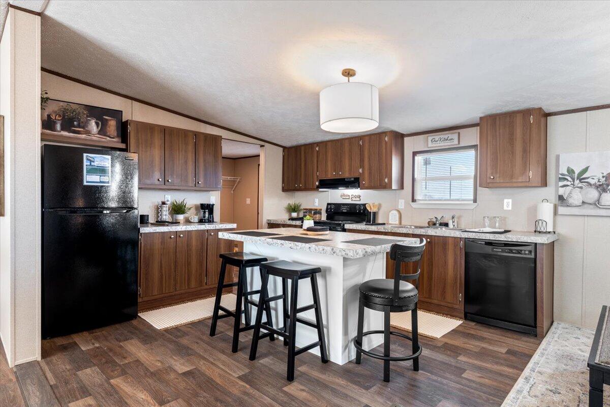 508 Sage Road Tahoka, TX 79373 - Photo 6 of 26 a kitchen with a refrigerator a stove a sink and a cabinets
