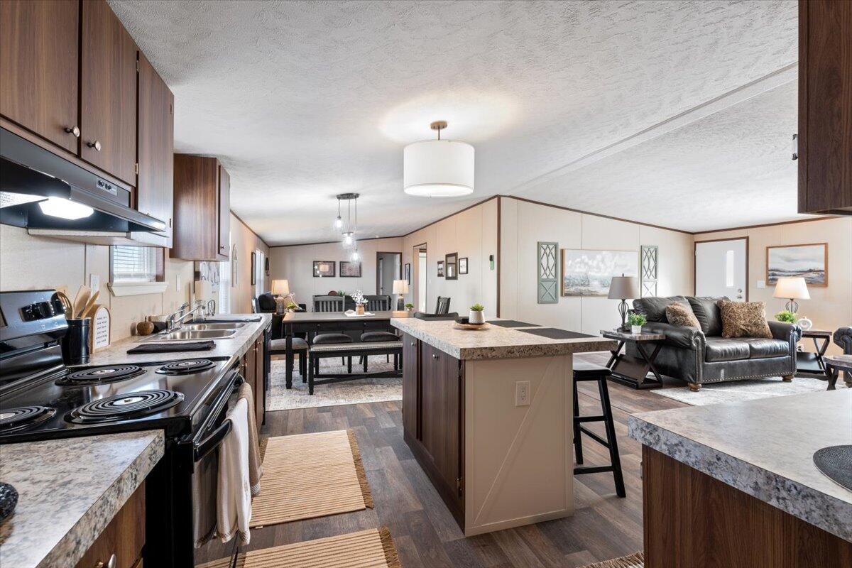 508 Sage Road Tahoka, TX 79373 - Photo 8 of 26 a kitchen with kitchen island a sink stove and cabinets