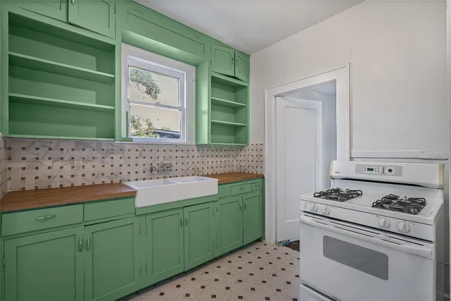 a kitchen with a sink cabinets and a stove top oven