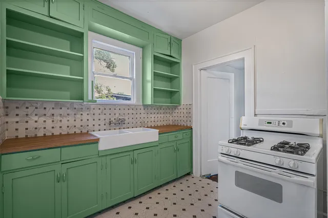 a kitchen with a sink cabinets and a stove