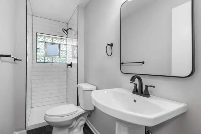 a bathroom with a sink toilet and shower