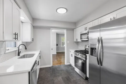 a kitchen with a sink stainless steel appliances and cabinets