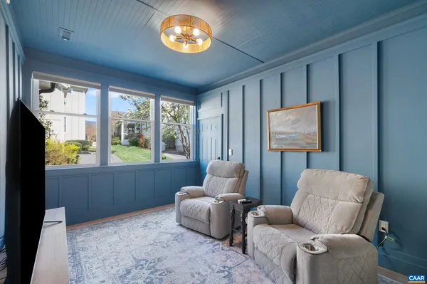 a living room with furniture a rug and a window