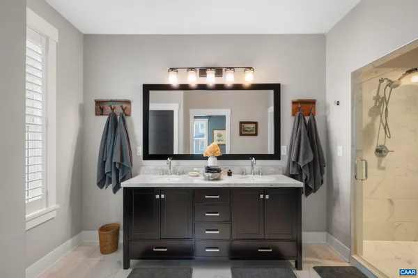 a bathroom with a sink vanity and a mirror