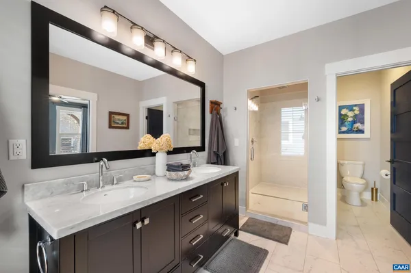 a bathroom with a sink double vanity and a mirror