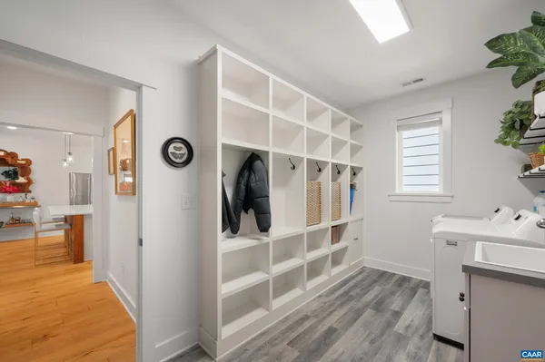 a view of entryway with workspace and wooden floor
