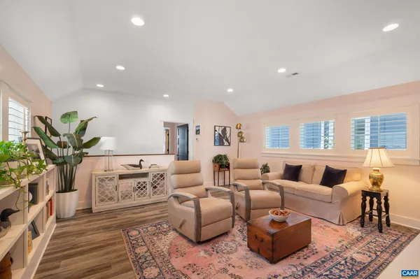 a living room with furniture or couch and a potted plant