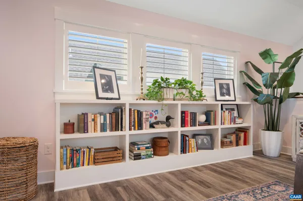 a living room filled with furniture and a book shelf