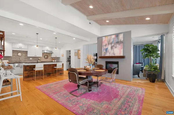 a living room with furniture a fireplace and a table