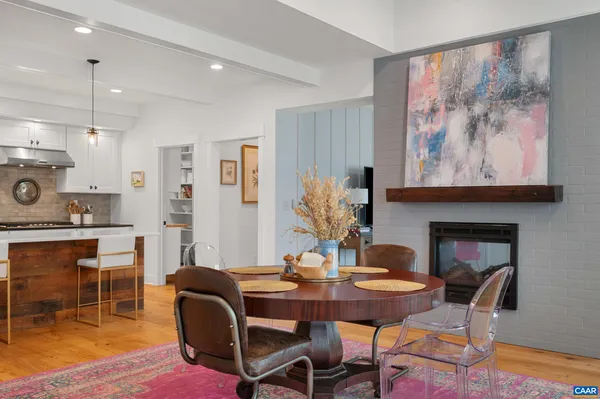 a view of a dining room with furniture wooden floor and a chandelier