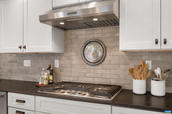 a kitchen with a stove and cabinets