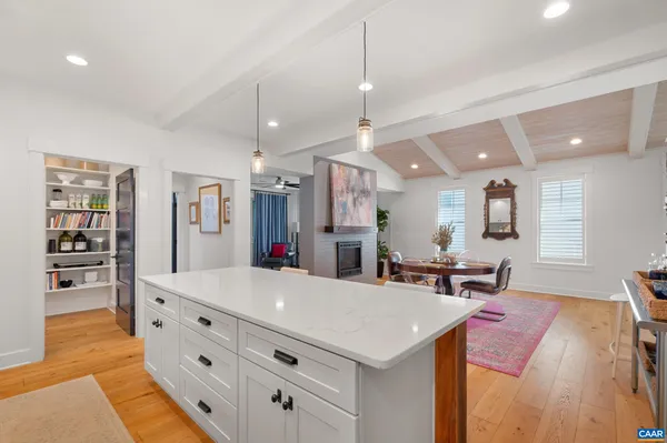 a large kitchen with a table and chairs