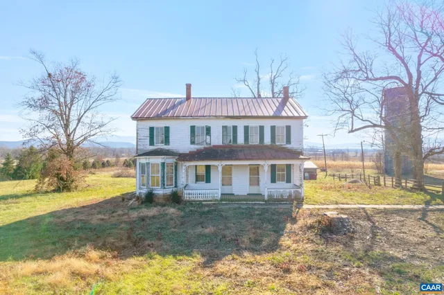 a view of a house with a yard and sitting area