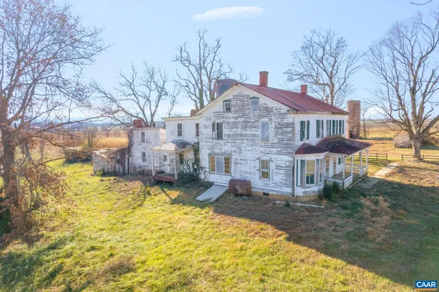 a view of a house with a yard covered with snow