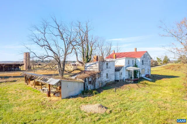 a view of a house with a yard and covered with snow