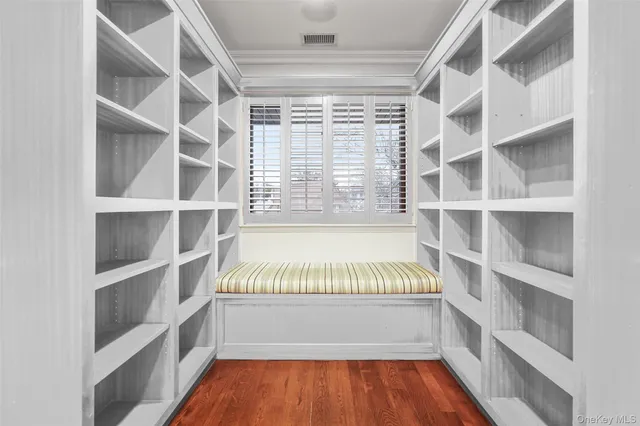 a view of walk in closet with empty racks