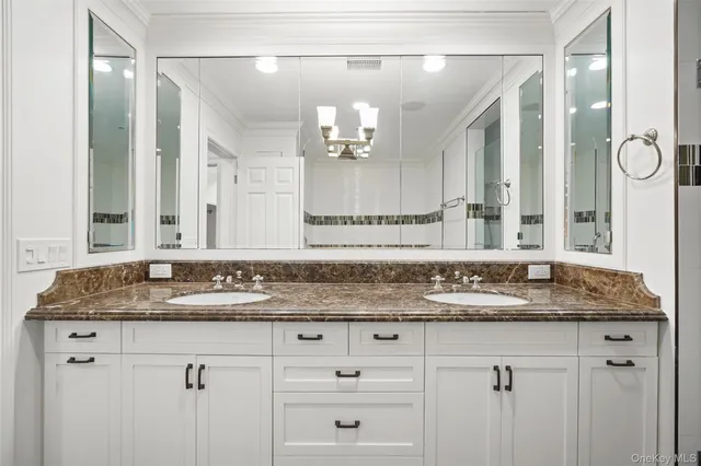 a bathroom with a granite countertop sink mirror and double