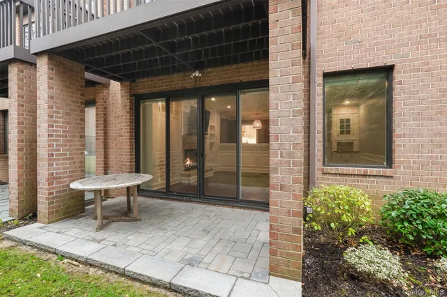 a building outdoor space with patio furniture and potted plants