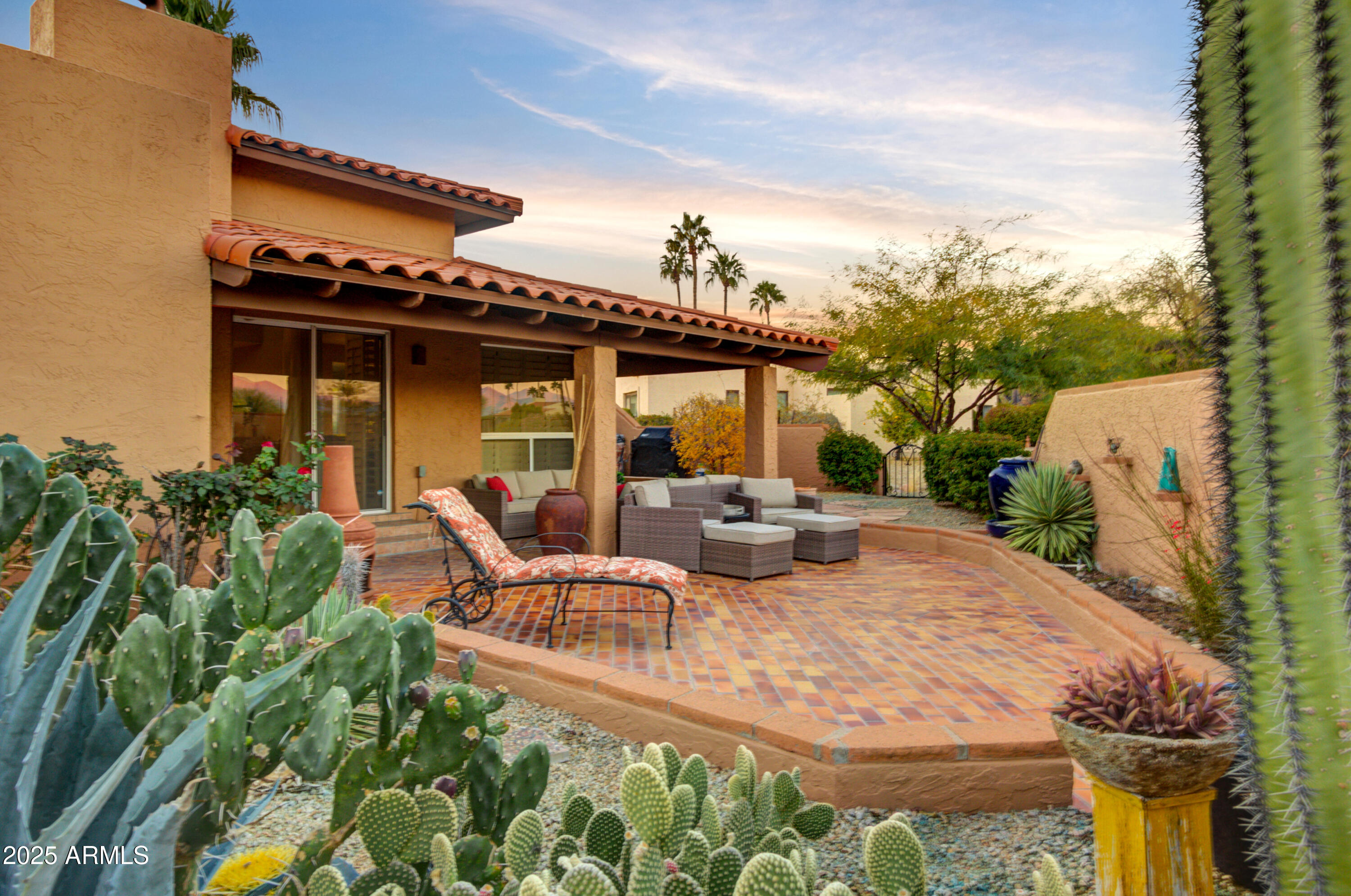 25828 North Primo Circle Rio Verde, AZ 85263 - Photo 16 of 21 a view of a patio with table and chairs potted plants with wooden fence