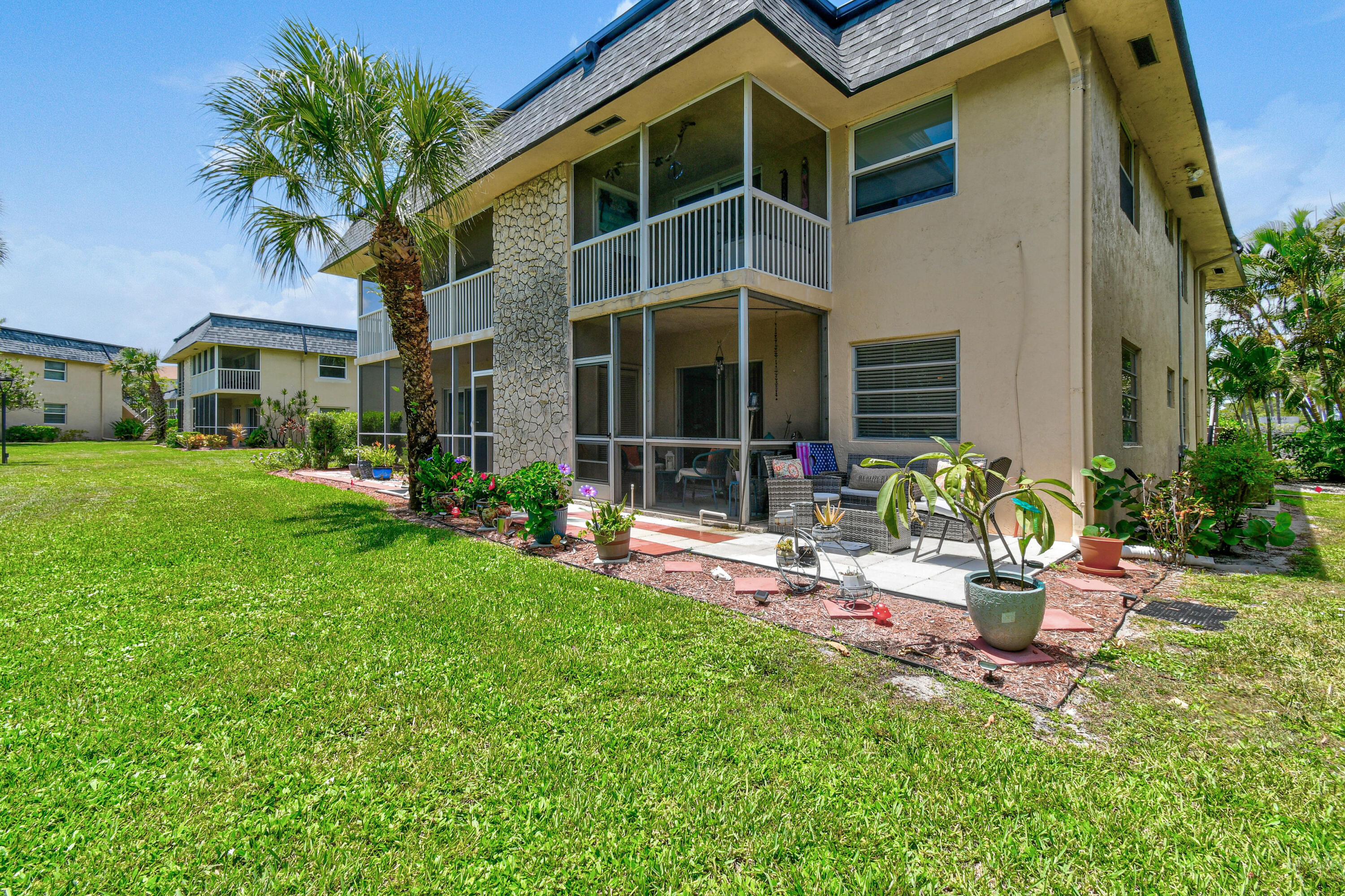 a view of a house with a yard and sitting area