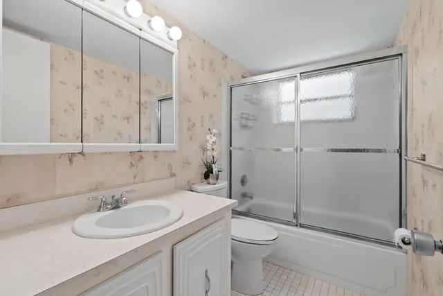 a bathroom with a sink toilet and shower