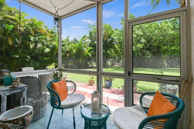 a view of a chair and tables in the patio
